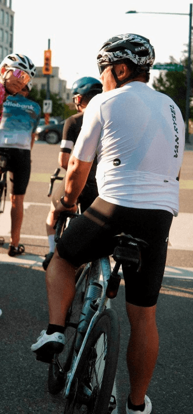 Wyn Hou on his bike, waiting at an intersection with the group